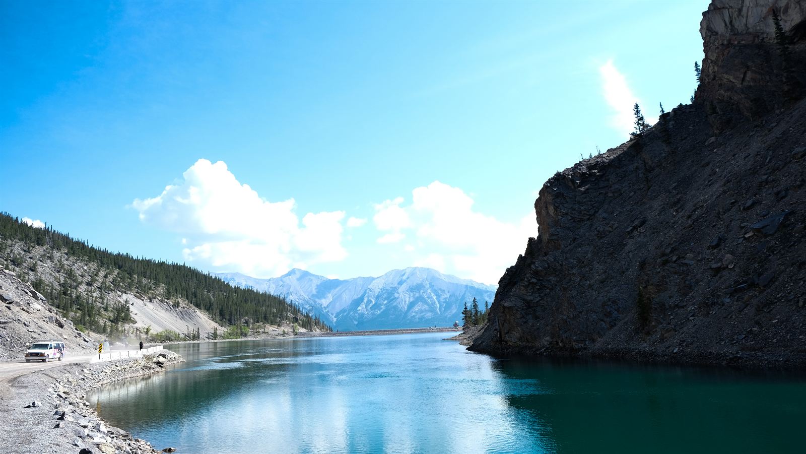 Turquoise reservoir along a mountain road near Canmore