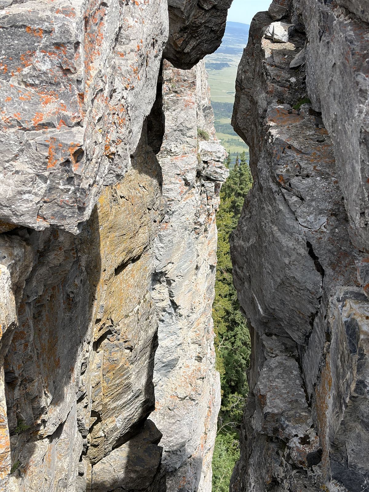 Foothills seen through a crack between summit rocks