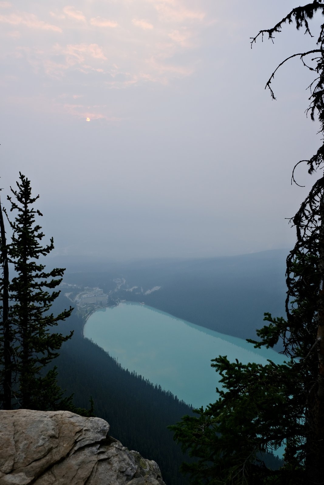 Lake Louise and the Fairmont chateau seen through wildfire haze, Banff