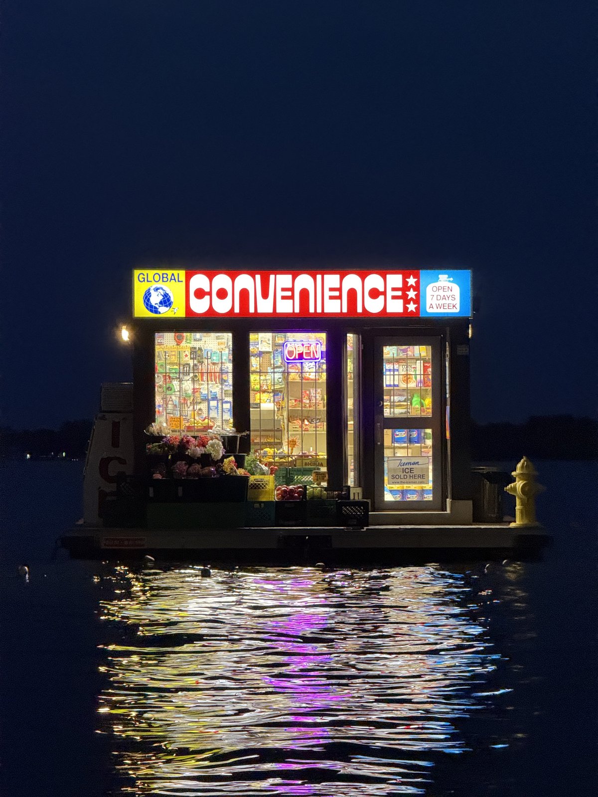 Floating convenience store lit up at night, Toronto Harbourfront